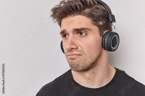 Obraz na plátně Headshot of displeased brunet adult man with unhappy expression dissatisfied by