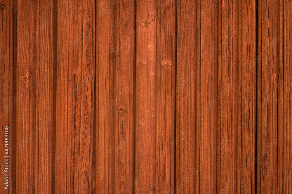 Wooden wall painted with protective red paint. Impregnation for rowan-colored wood. Lining for finishing the house. Wooden texture with a clean place for text. Wooden wall painted with protective red paint. Impregnation for rowan-colored wood. Lining for finishing the house. Wooden texture with a clean place for text.