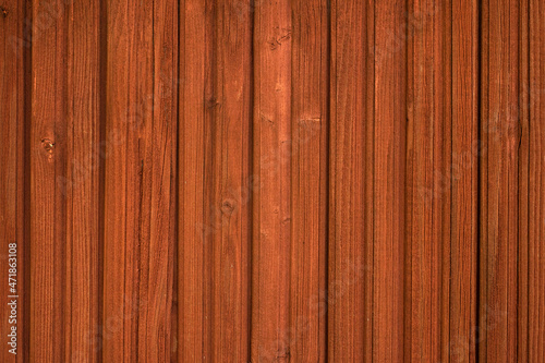 Wooden wall painted with protective red paint. Impregnation for rowan-colored wood. Lining for finishing the house. Wooden texture with a clean place for text.