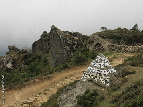 Painted and carved mani stome in Namche Bazaar, Nepal. photo