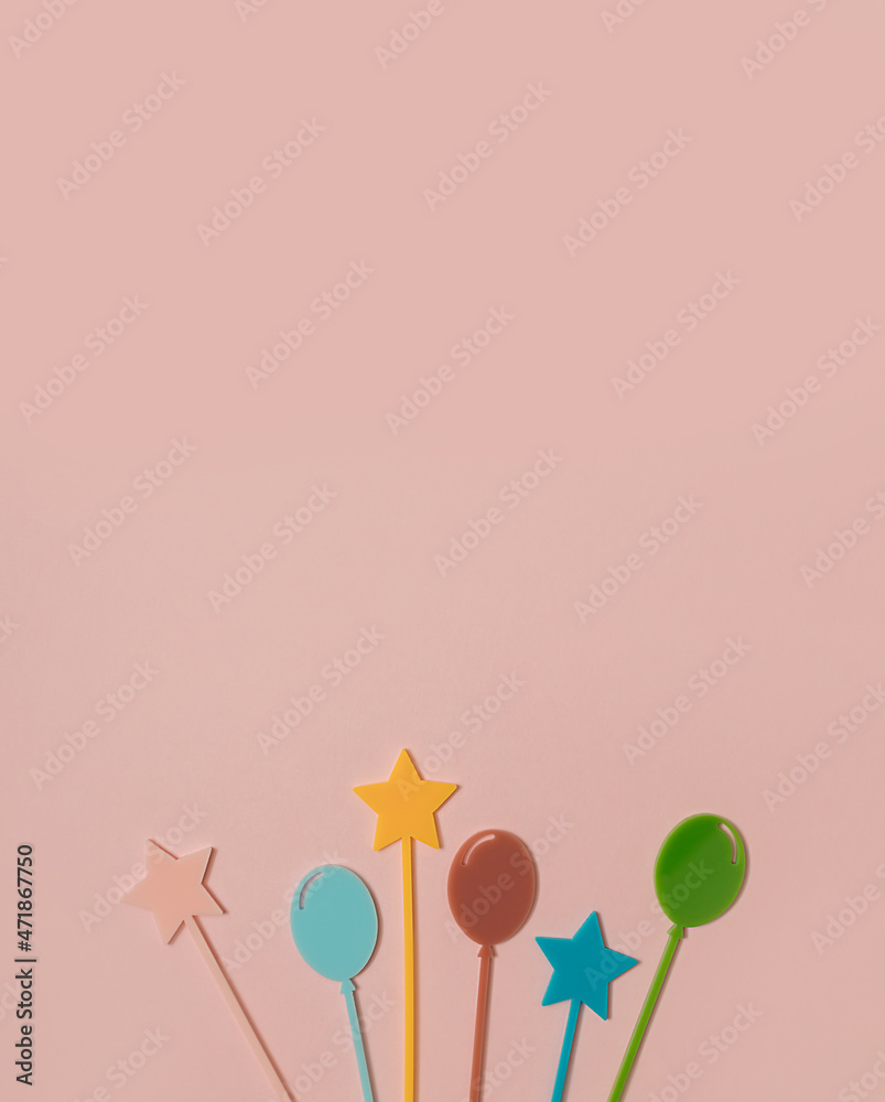 Colourful cocktail cupcake picks star and balloon shaped on pastel pink background. Minimal Happy birthday flat lay. Celebration card or party concept. Holiday idea. Copy space.