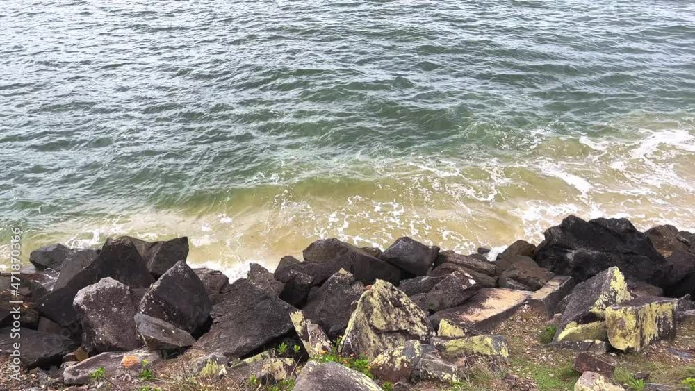 A view wave surface of the river channel behind the coastal rock retaining wall close to the river mouth showing sand deposited along the river edge from the sea.
A view wave surface of the river channel behind the coastal rock retaining wall close to the river mouth showing sand deposited along the river edge from the sea.