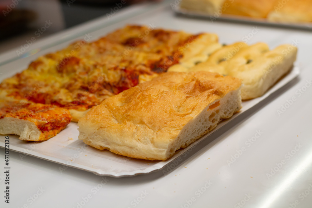 Fresh baked pastry pie and pizzas in small bakery in Parma, Emilia Romagna, Italy