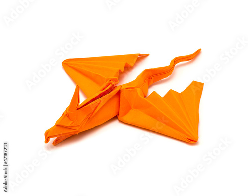 Photo of origami orange dragon isolated on white background