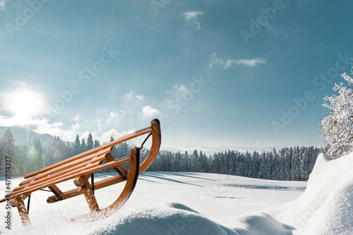 Holzschlitten in einer verschneiten Winterlandschaft