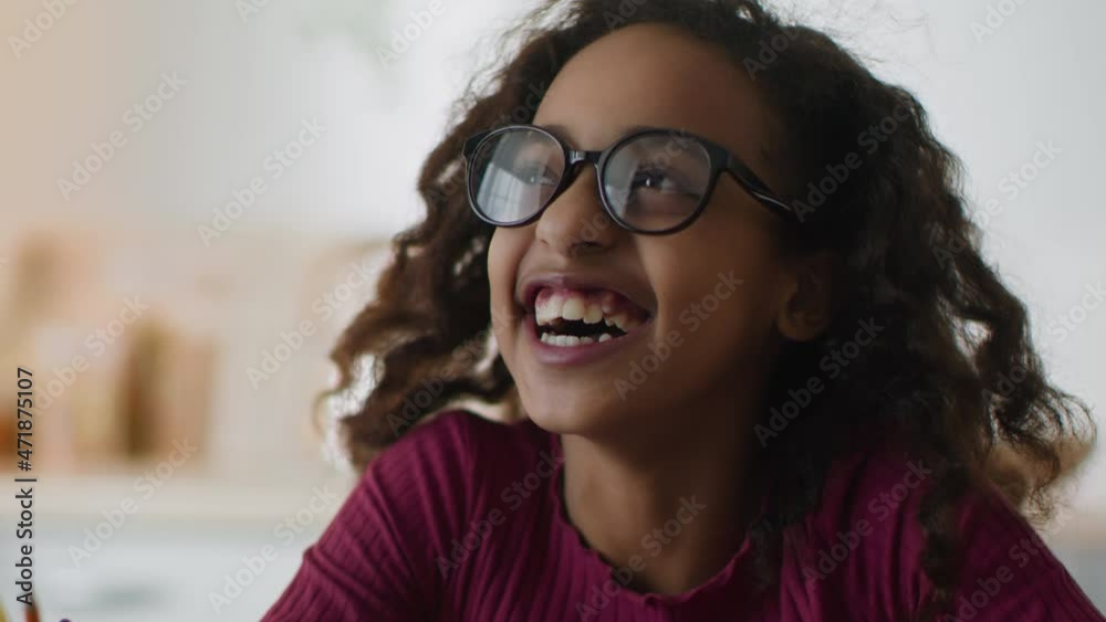 Fun and happiness. Close up portrait of adorable happy funny girl nerd wearing eyeglasses laughing loud at home