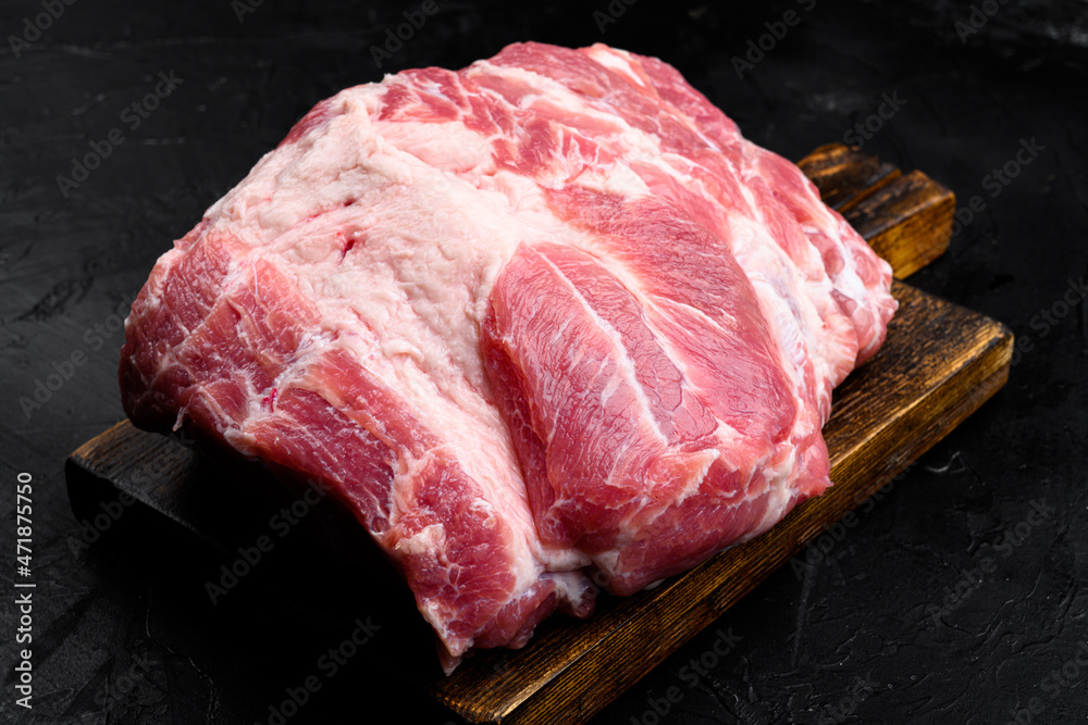 Pork shoulder fresh raw meat, on black dark stone table background