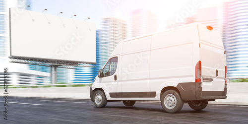 Delivery van moving to downtown skyscrapers and empty billboard. Express delivery and moving. photo