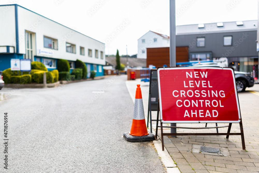 Fototapeta premium 'New level crossing control ahead' sign in a town centre informing the public of the change