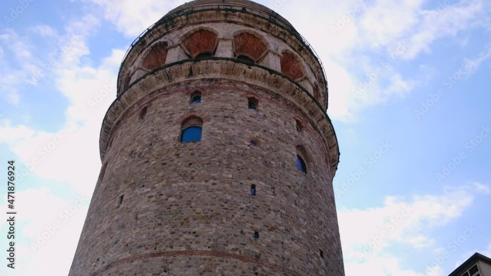 Bottom up view of Galata Tower against cloudy blue sky. Istanbul, Turkey. Bottom up view of Galata Tower against cloudy blue sky. Istanbul, Turkey.