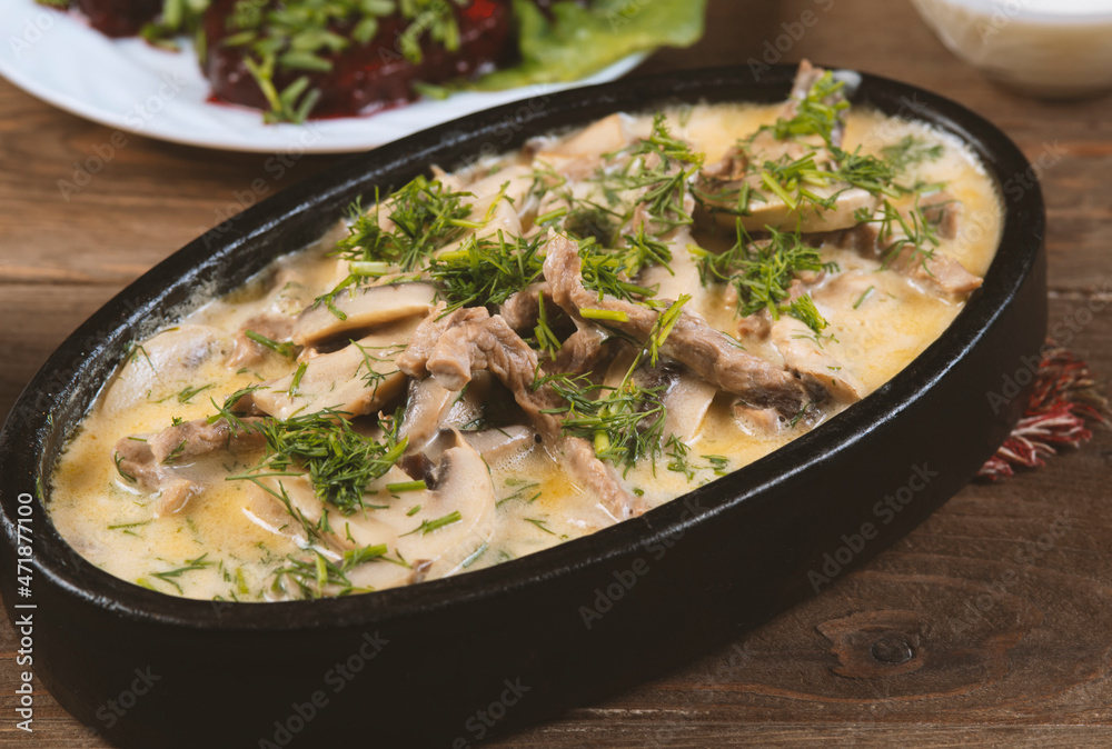 Beef and mushroom stew in a creamy sauce served in a pan