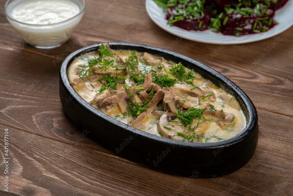 Beef and mushroom stew in a creamy sauce served in a pan