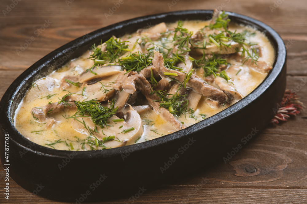 Beef and mushroom stew in a creamy sauce served in a pan