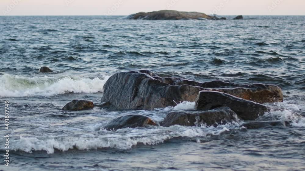 Giant waves crashing at rocky sea cliffs with splashing white foam. Water is flowing over stones. Abundant clear stream in a sea shore. Coldwater splashing near rapids. Concept of water background. Giant waves crashing at rocky sea cliffs with splashing white foam. Water is flowing over stones. Abundant clear stream in a sea shore. Coldwater splashing near rapids. Concept of water background.