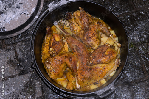 Crispy browned  roast chicken in the dutch oven.