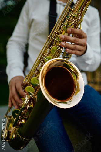 Photography Male saxophonist plays the saxophone in park