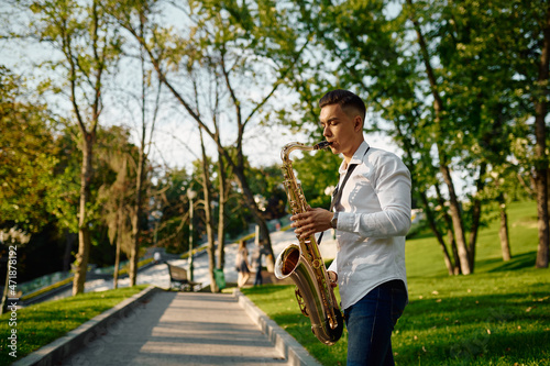 Photography Young saxophonist plays the saxophone in park