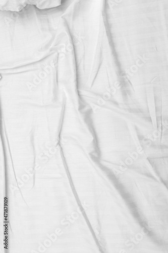 White wrinkled bed background, texture. © Prikhodko
