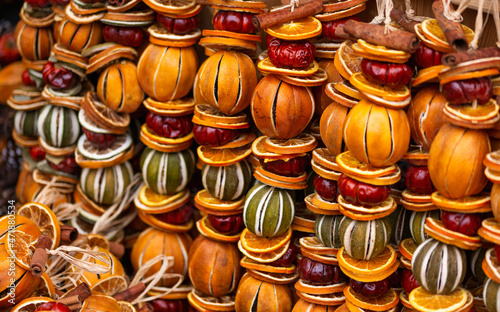 handmade ecofriendly Christmas decoration made from dried oranges, fruits, cinnamon sticks and nuts for sale on Christmas market