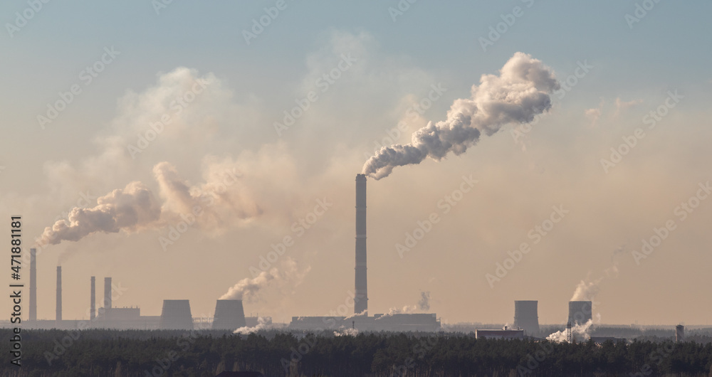 Factory chimneys smoke into the sky. Ecology of nature.