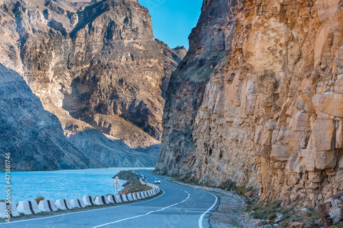 The confluence of the Avar koysu and the Andi koysu into the Sulak river. Blue water of the Sulak river among the rocks. Asphalt road in the mountains in Dagestan, Russia photo