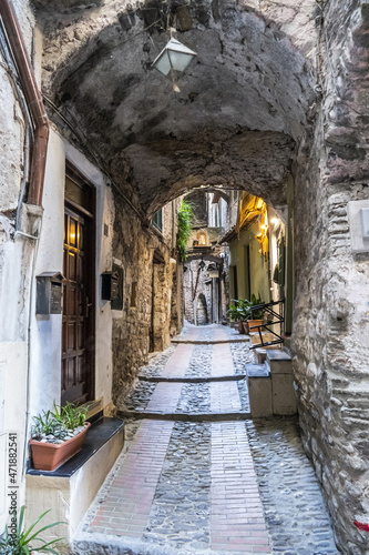 Characteristic small streets in the historic center of Dolceacqua with arches and flowers