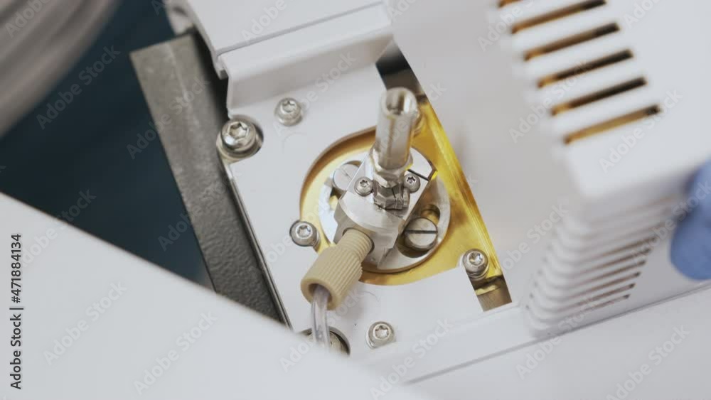 Close up scientist insert a nebulizer needle into into source of mass spectrometer. Liquid chromatography with mass detection for pharmaceutical analysis. Maintenance of LC MS qTOF Close up scientist insert a nebulizer needle into into source of mass spectrometer. Liquid chromatography with mass detection for pharmaceutical analysis. Maintenance of LC MS qTOF