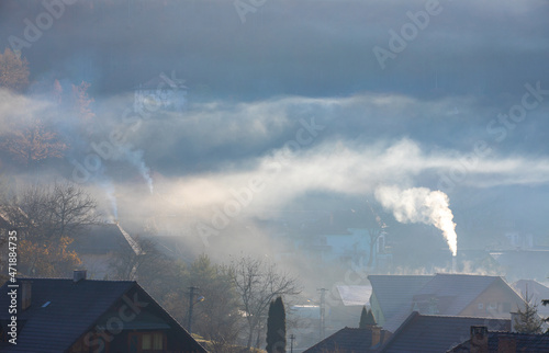 smoke from the chimneys of the houses over the village
