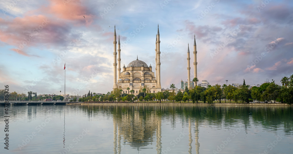 Fototapeta premium Sabanci Central Mosque in Adana, Turkey on Seyhan River. Mosque has reflections in sunny day with blue sky