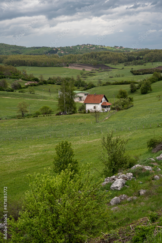 The natural landscape, the beauty and majesty of green meadows and forests. Top view. Rural house in field. The natural landscape, the beauty and majesty of green meadows and forests. Top view. Rural house in field.
