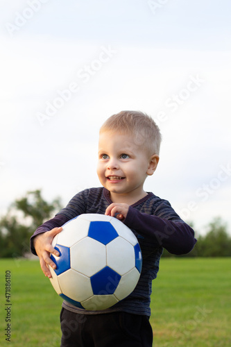 Young Football Player On The Grass Field