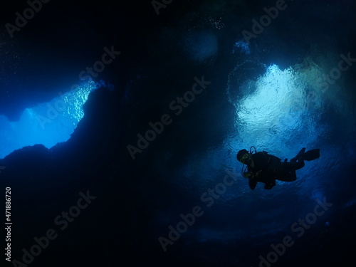 sun rays sun beams and sun shine underwater in cave beautiful light scenery in ocean scuba divers to see in cave