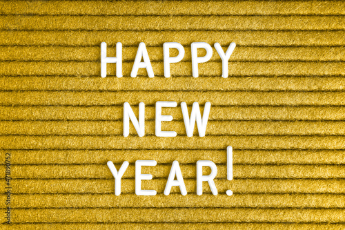 Happy new year , text on yellow felt letter board with white letters . Top view, flat lay photo