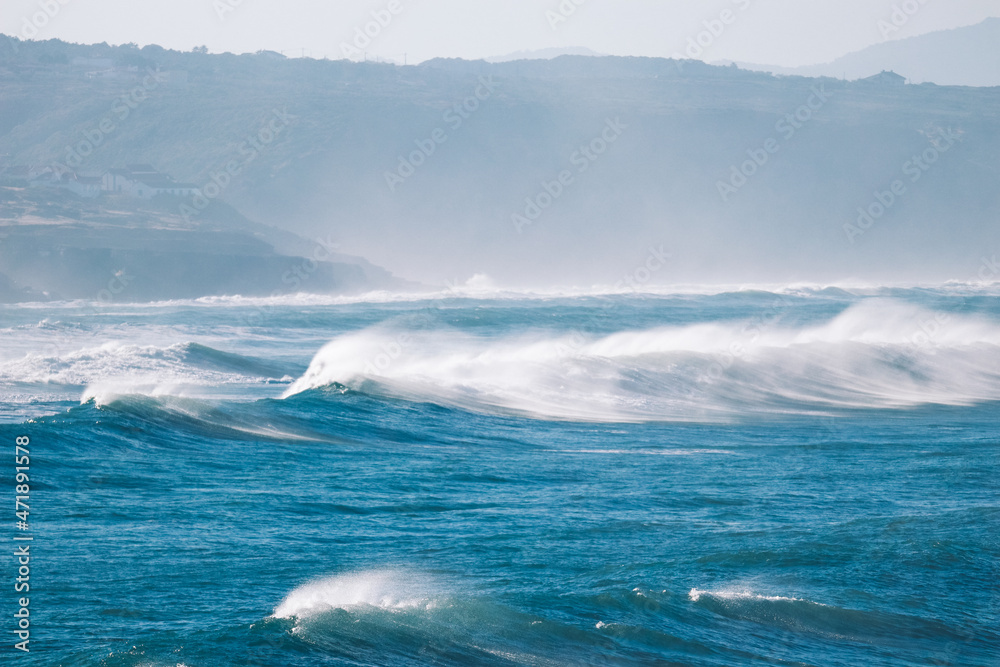 Big breaking Ocean waves hit the coastline. Strong wave