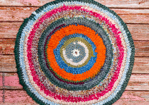 Colorful vintage handicraft rug made from strips of cloth as background