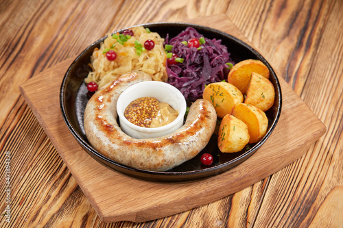 Traditional german fried meat with boiled potatoes, red cabbage and vegetables