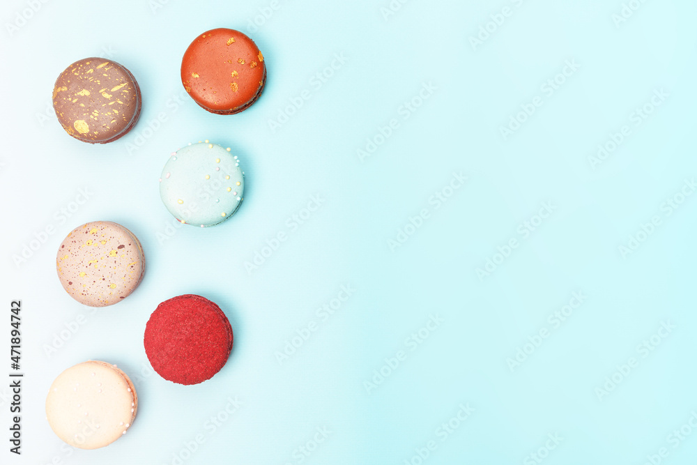 Six multicolored macaroons on a blue background Six multicolored macaroons on a blue background