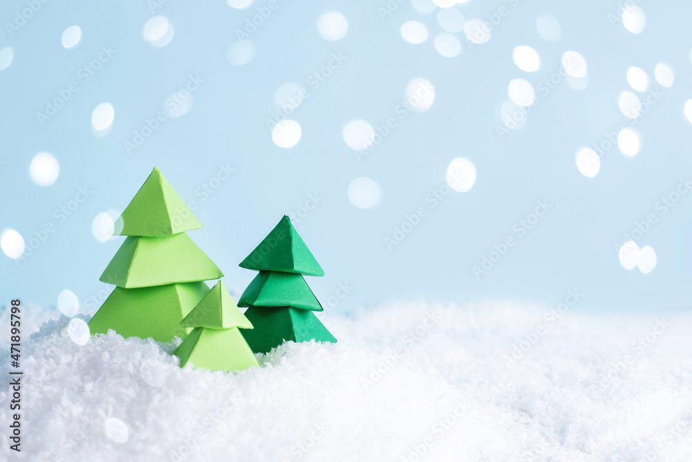 Christmas and winter card, three green paper trees on snow