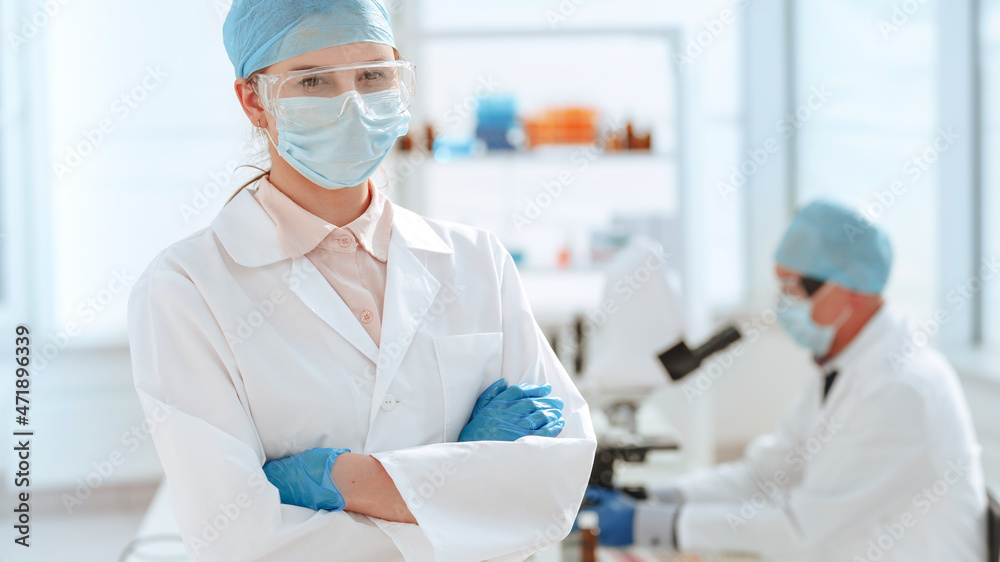 close up. doctor in a protective mask standing in the laboratory. close up. doctor in a protective mask standing in the laboratory.
