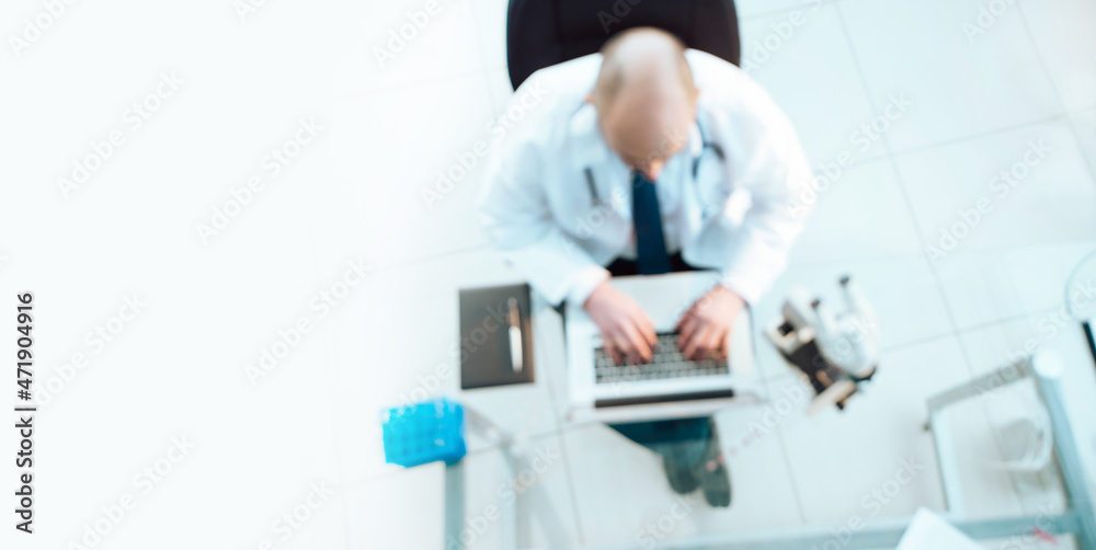 science lab technician using a laptop during his research. science lab technician using a laptop during his research.