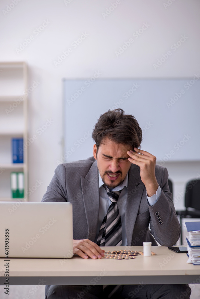 Young businessman employee suffering at workplace Young businessman employee suffering at workplace