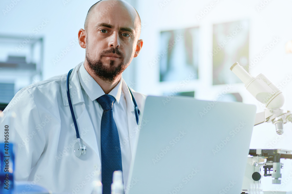 young scientist sitting at a table in a medical laboratory. young scientist sitting at a table in a medical laboratory.