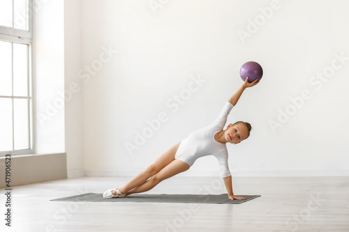 Little girl doing gymnastic...