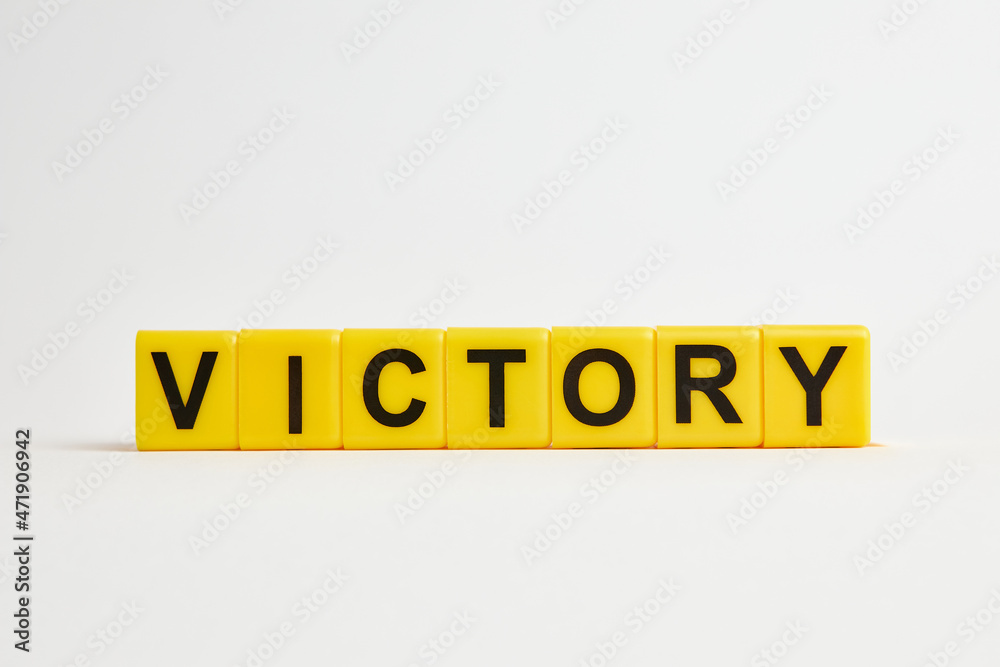 The word victory consists of individual cubes with letters. The word victory consists of individual cubes with letters.