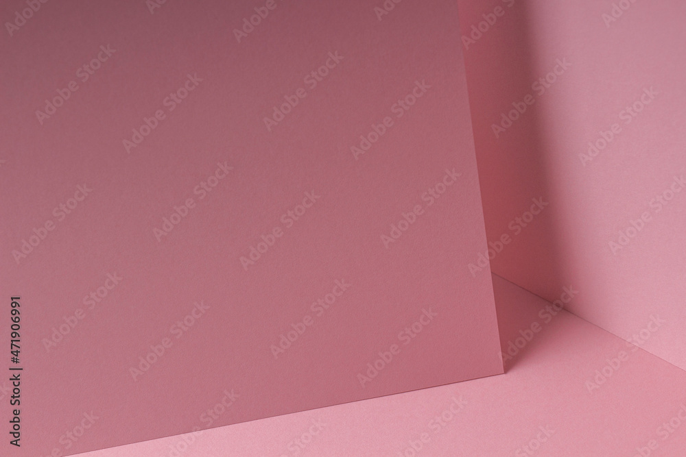 Blank pastel pink paper sheet card note with shadows. Abstract geometric monochrome pink background with copy space for text. Front diagonal view Blank pastel pink paper sheet card note with shadows. Abstract geometric monochrome pink background with copy space for text. Front diagonal view