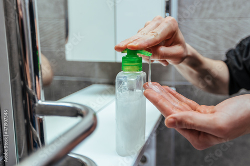 close up. man using a bactericidal hand soap.
