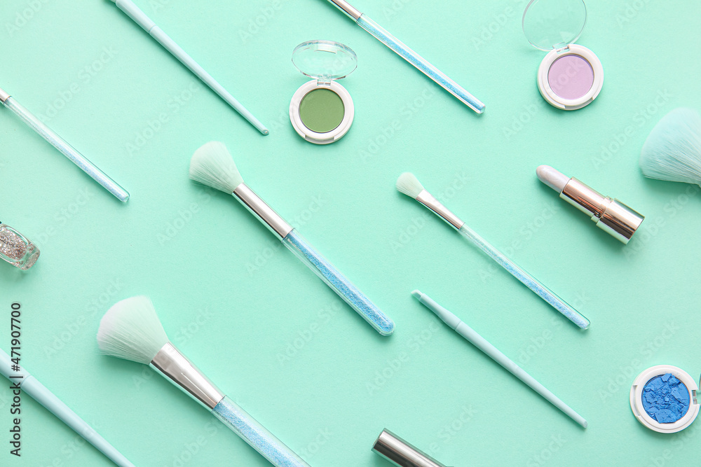 Set of decorative cosmetics with makeup brushes on color background