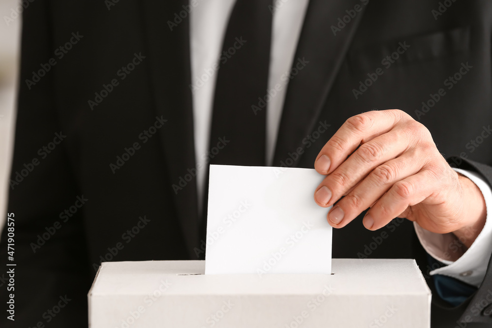 Voting man near ballot box, closeup view Voting man near ballot box, closeup view