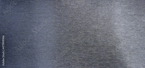 Metallic texture in black. Rectangular metal strip with thin horizontal stripes. Dark background of metallized vinyl film. Grey stainless steel texture. photo