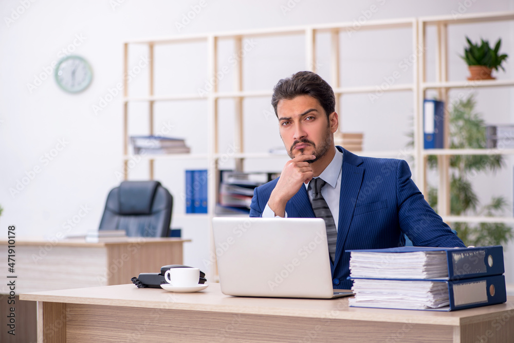 Young handsome employee working in the office Young handsome employee working in the office